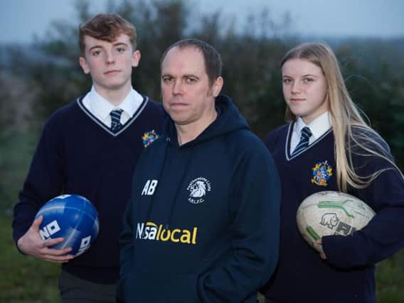 Andrew Bell has set up a petition to keep rugby league back at Featherstone Academy after fears the school would replace it with union. Pictured are Andrew with his two children Elliott and Millie