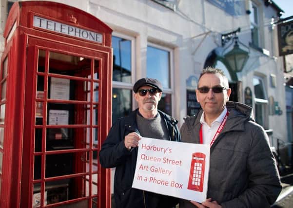 Darren Byford and Graham Roberts (chair of civic society) at the phone box which is to be converted into an art gallery.