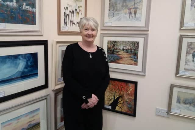 Artworld Gallery showcases and sells paintings from artists in the district and beyond. Pictured is Sandra Bradbury