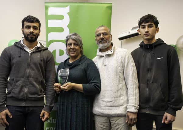 Waheeda Janmohamed receives one of the MEND awards with her family Afzal, Azan & Shaariq.
