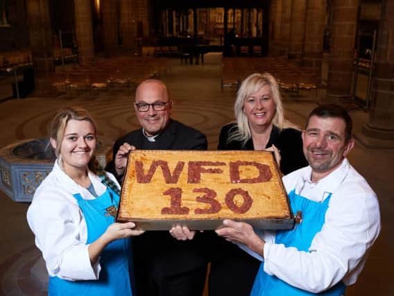 Nigel Hofmann and his daughter Emily have made a WFD PIE to celebrate Wakefield BIDs WFD 130 campaign marking the citys 130th anniversary of city status. Pictured in Wakefield Cathedral with the Dean of Wakefield Very Revd Simon Cowling and Elizabeth Murphy, manager of Wakefield BID.