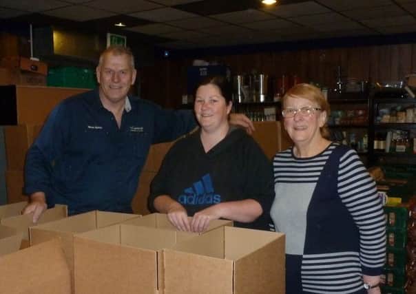 Gemma Jimmison from the Wakefield Express (centre) with Simon Burrow and Shirley Smith from the Rotary Club of Wakefield Chantry with the final few hampers.