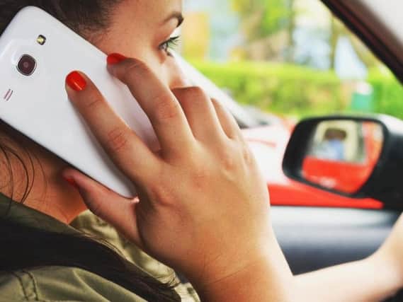 People are still dangerously using their mobile phones while driving.