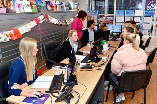 Busy: Staff at One World Travel speak to customers in Wakefield