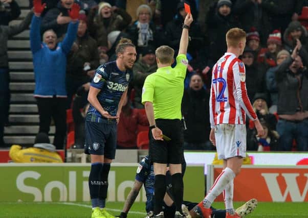 Luke Ayling appeals to referee Gavin Ward after Pontus Jansson (on the ground) is red carded at Stoke City. Picture: Bruce Rollinson