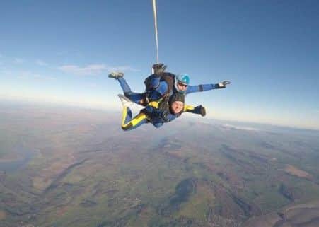Raising: George completed a sky dive over the Lake District.