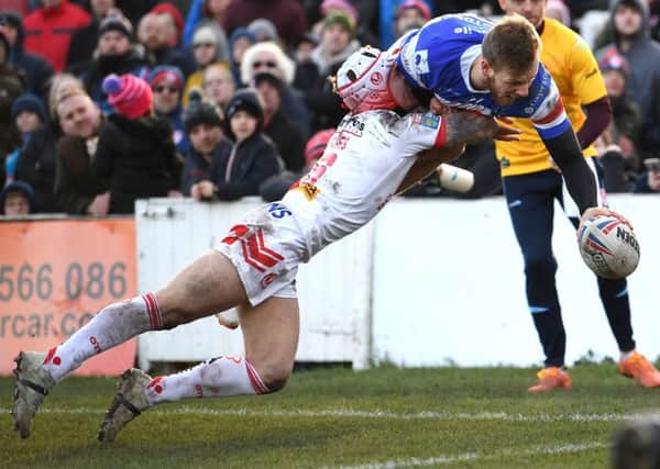 Wakefield's Tom Johnstone beats Saints Theo Fages to claim his spectacular first try. PIC: Jonathan Gawthorpe