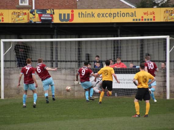 AFC Emley's Wayne Hughes (6) scores from the rebound after Hallam FC goalkeeper Dave Darwent saved his penalty. PIC: Mark Parsons.