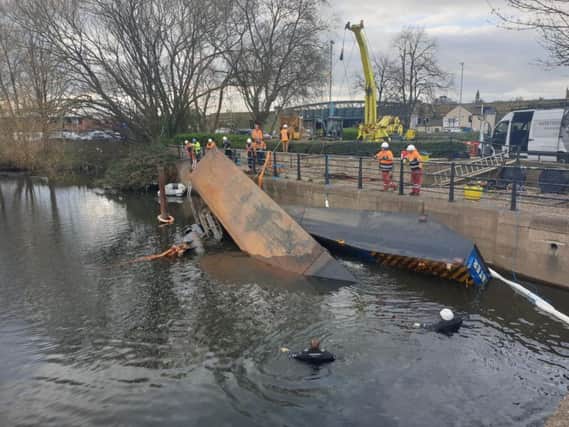 Attempts are made to salvage one of the overturned boats (pic by @LAWphotography1)
