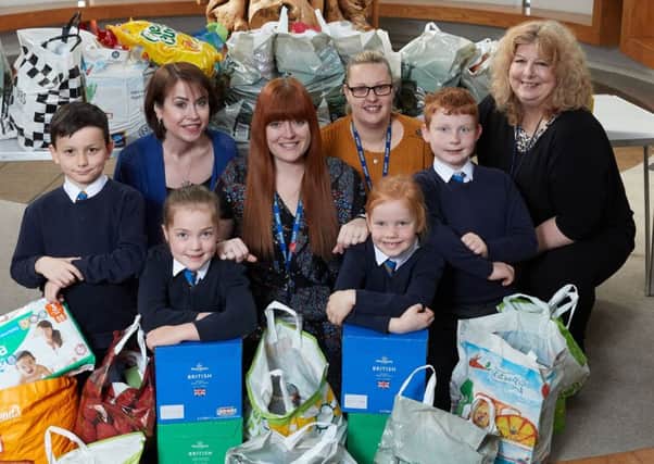 lending a hend: Pupils from Hendal Primary filled up 20 bags of food for St Catherines.
