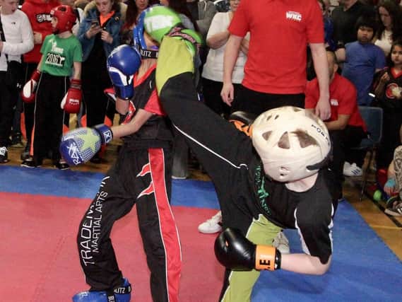 George Emsley lands a head kick in one of his kickboxing contests at the National Championships.