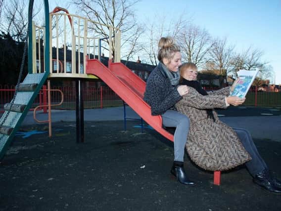Zoe Gaitley and Jo Pollitt with plans for the new play area before it was attacked by vandals.
