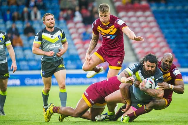 Dave Fifita is brought down by Michael Lawrence. PIC: James Heaton.
