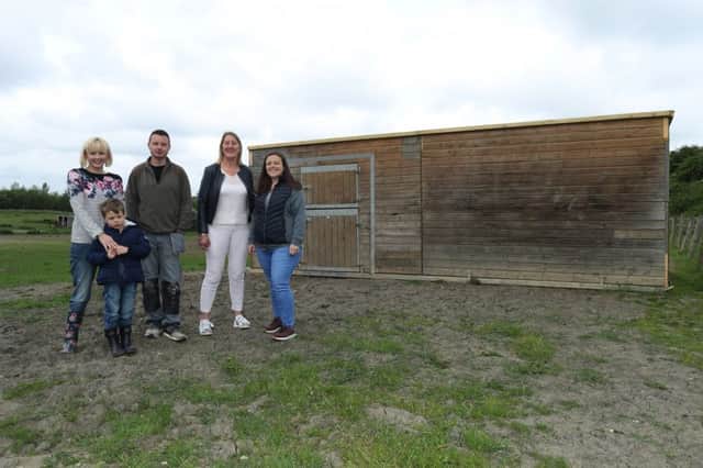 Hayley Edwards appealed for help after her stable were destroyed. Lots of people stepped forward and it is now complete. Pictured are Hayley Edwards, Nathan Hudson, Kathryn Scott, Lisa Wells and Steven Wells
