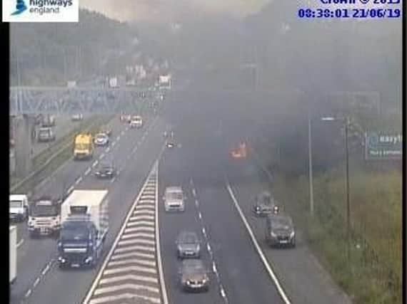A car is on fire on the M62 at the exit slip to the M621. Photo: Highways England.