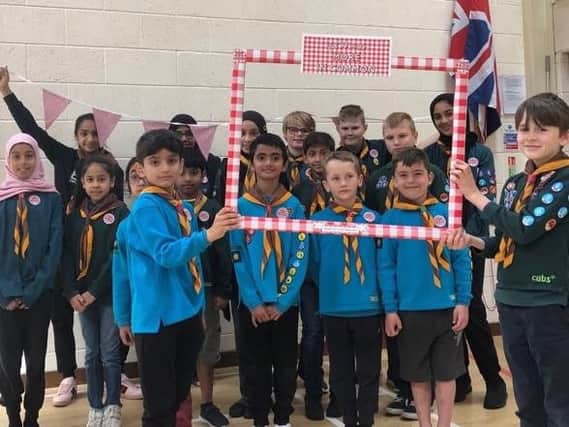 Members of Heckmondwike Scout Group show off their More In Common badges.