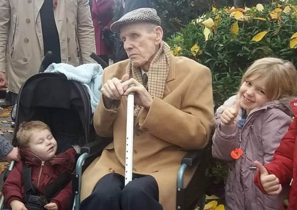 Stan, pictured with two of his great grandchildren, loved spending time with his family.