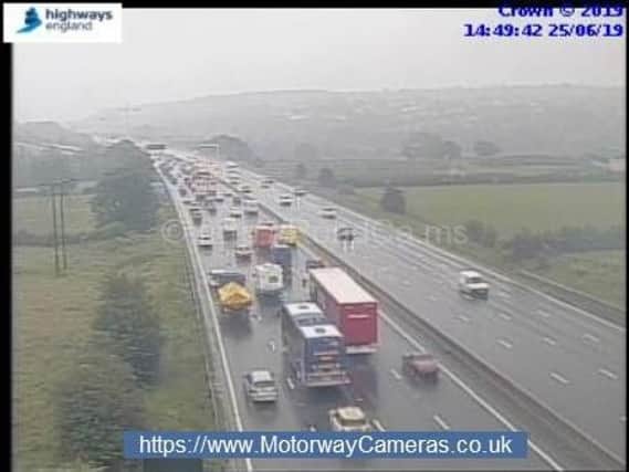 Motorists have been warned of up to 30 minutes of delays after flooding closed a lane of the M1. Picture: Highways England.