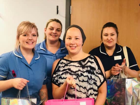 Sherine Hampshire presents the luxury packs to chemotheraphy nurses at Pinderfields Hospital.