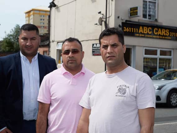 Taxi driver Muhammad Akram (right) was left for dead by passengers who beat him unconscious and robbed him. He is pictured with Wajid Ali, co-chairman of Wakefield District Private Hire and Hackney Association and Yasar Ahmen, association treasurer.