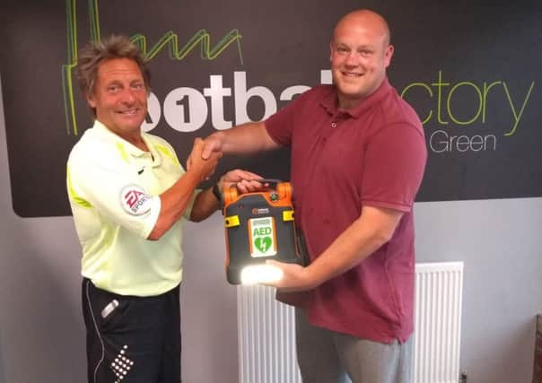 Alan Haywood recieves a defibrillator for the A1 Football Factory (Yorkshire Health and Sport), donated by Dale Skelton of Multifuel Energy.