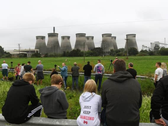 People gather to get a good viewing spot before the first of the Ferrybridge cooling towers is demolished.