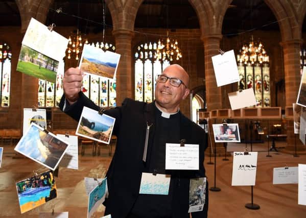 The Very Revd Simon Cowling Dean of Wakefield, with the favourite Places Favourite Journeys postcards hanging at Wakefield Cathedral.