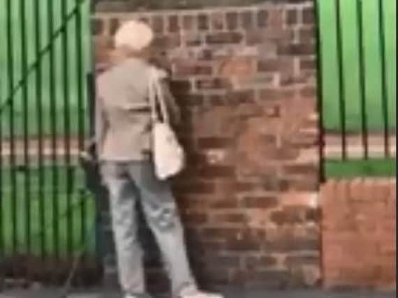 Carla Petts filmed the woman writing messages on the wall. (Picture from Carla Petts)