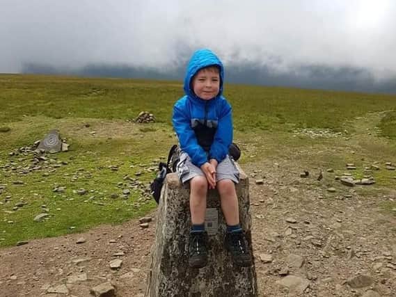 Charlie Batham has climbed half the height of Mount Everest at the age of just five. Pictured at the top of Ingleborough Mountain. Photo: Paul Batham.