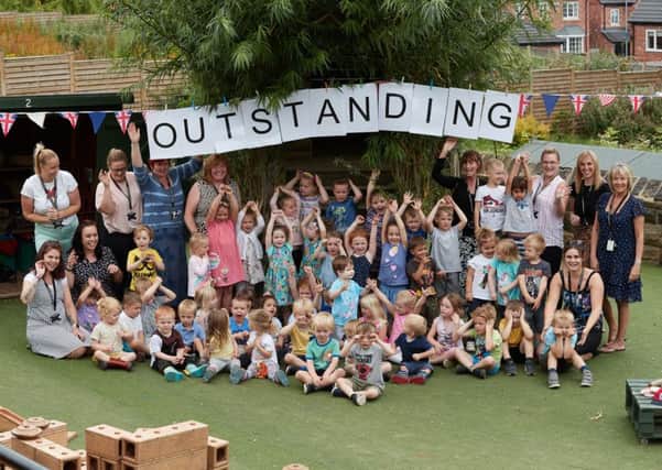Staff and pupils celebrate getting an outstanding Ofsted mark.
