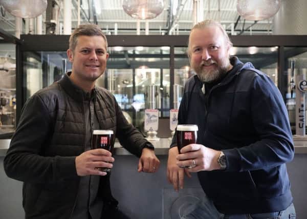 Cheers: Alex Minett and Jamie Lawson share a toast to the future.