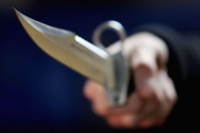 LONDON, DECEMBER 13:  A hunting knife is held by an employee at a film and television prop company December 13, 2004 in London, England. Families of stabbing victims have called on the government to make carrying a knife as serious an offence as carrying a gun, with a minimum five-year jail term for carrying a knife with a blade longer than three inches. (Photo Illustration by Ian Waldie/Getty Images)