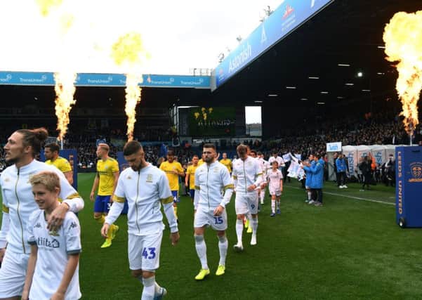 Leeds United's Luke Ayling leads the players out as the fireworks go off at Elland Road.