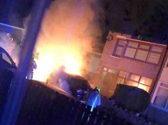 Fire engulfs a car outside Kirklees councillor Masood Ahmeds home in Dewsbury.