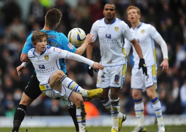 Chris Dawson, on his debut for Leeds United, holds off Derby County's Jeff Hendrick.