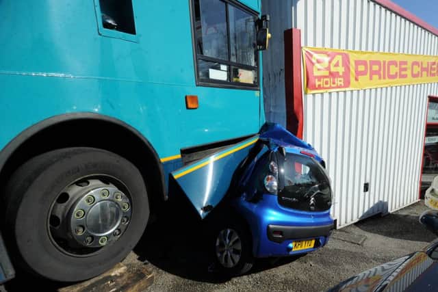 The scene at Silvers garage, Pontefract, where a double decker bus has crushed a car at the garage..16th May 2013..Picture By Simon Hulme