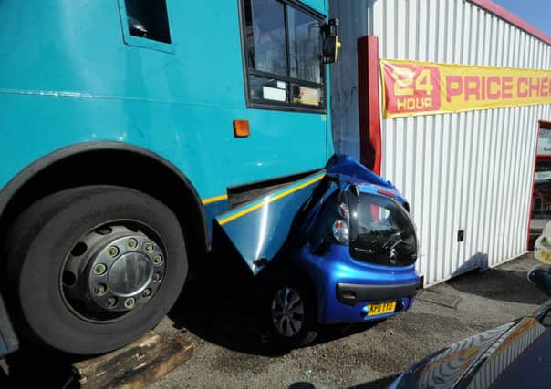 The scene at Silvers garage, Pontefract, where a double decker bus has crushed a car at the garage..16th May 2013..Picture By Simon Hulme