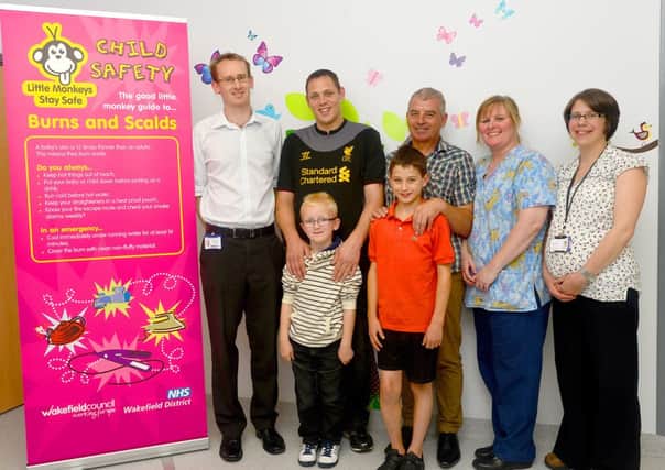 The launch of the scalds campaign at Pinderfields Burns Unit. DR Jamie Yarwood, Arron and Kaydon Connah, Liam and Sean White, Tracy Foster and Jane Stark with the capaign poster. (W513E325)