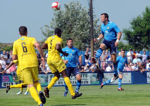 Noel Hunt rises to head home his first goal for Leeds United against Farsley.