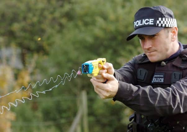 A policeman demonstrating a Taser stun gun