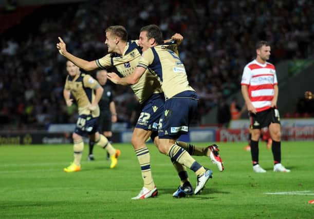 Leeds United's Scott Wootton celebrates with Jason Pearce after scoring on his debut at Doncaster.