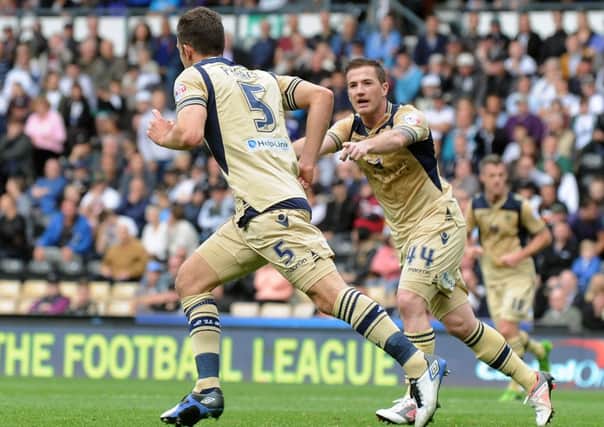 Jason Pearce turns to celebrate with Ross McCormack after scoring for Leeds United at Derby.
