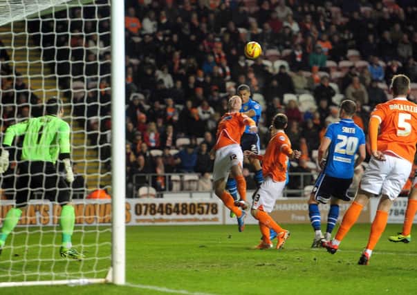 Lee Peltier gets in a header to score Leeds United's goal at Blackpool.
