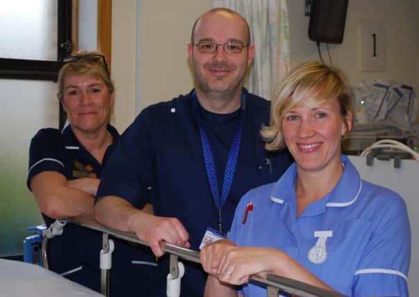 TOPPING TABLE Senior sister Deborah Walmsley, emergency nurse practioner Jonathan Atkinson and staff nurse Gemma Shuttleworth in Dewsbury A&E.
