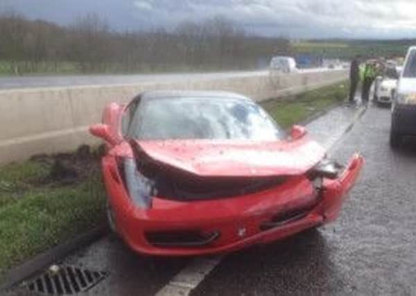 A Ferrari car crashed into the central reservation of the M1