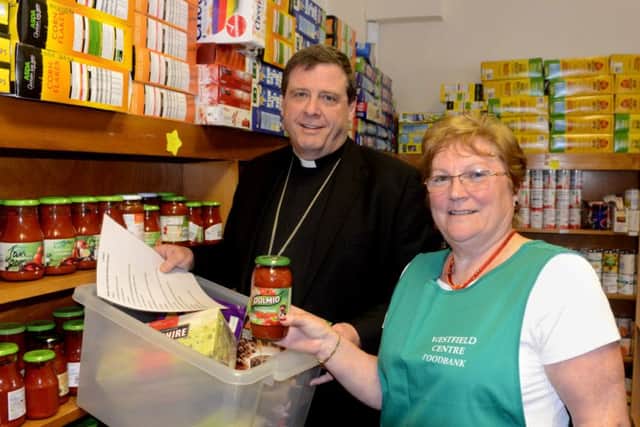 The bishop of the Wakefield  Tony Robinson,  visiting Bernadette France at the Westfield Centre food bank to express his support.  (p611a421)