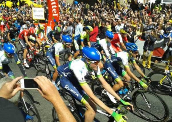 Riders set off for the Tour de France watched by thousands of people in Leeds city centre this morning.