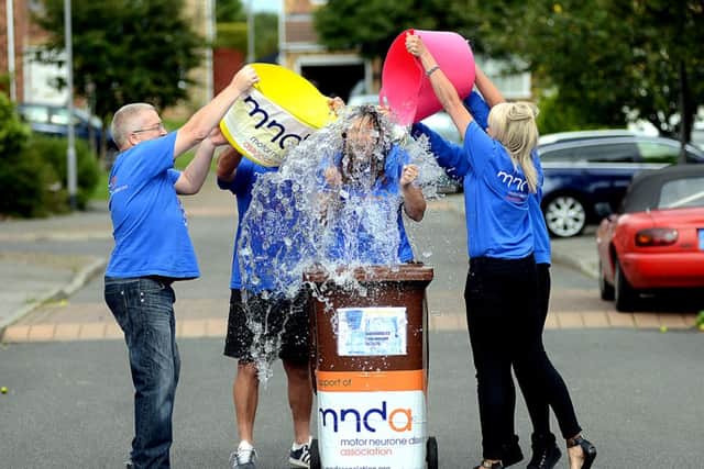Paula Maguire from Ryhill, taking the Ice Bucket Challenge whilst stood in a cleaned wheelie dustbin full of ice water, to raise awareness for MND (Motor Neurone Disease) - helping are family members and friends.
h308c433