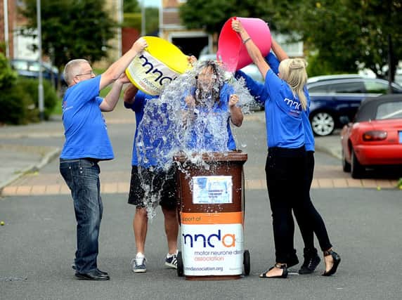 Paula Maguire from Ryhill, taking the Ice Bucket Challenge whilst stood in a cleaned wheelie dustbin full of ice water, to raise awareness for MND (Motor Neurone Disease) - helping are family members and friends.
h308c433