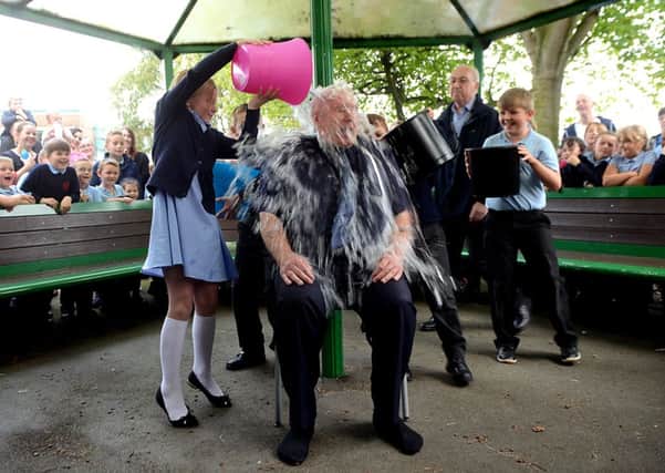 Ice Bucket Challenge by the Leader of Featherstone Town Council, Graham Isherwood in aid of Macmillan nurses. The challenge was done in the grounds of North Featherstone J+I school and the honour of pouring the buckets of water over Graham Isherwood went to some of the pupils from the school.
p328b437